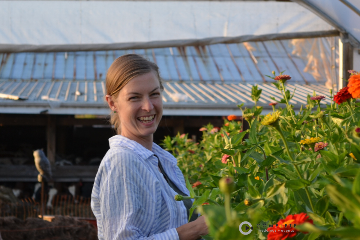 anna merkt headshot in greenhouse with a big smile
